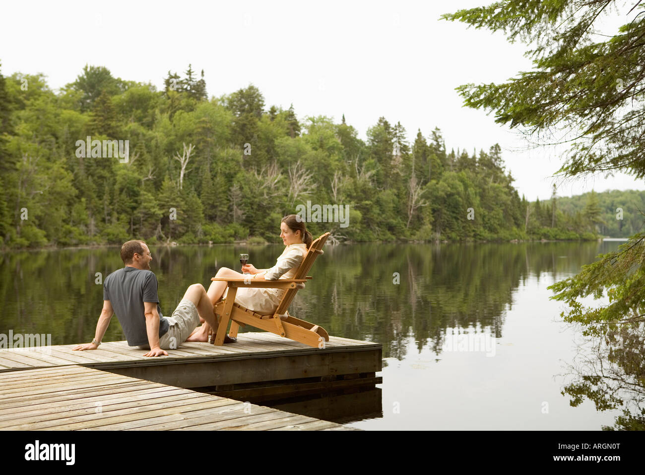 Couple on Dock by Lake Stock Photo