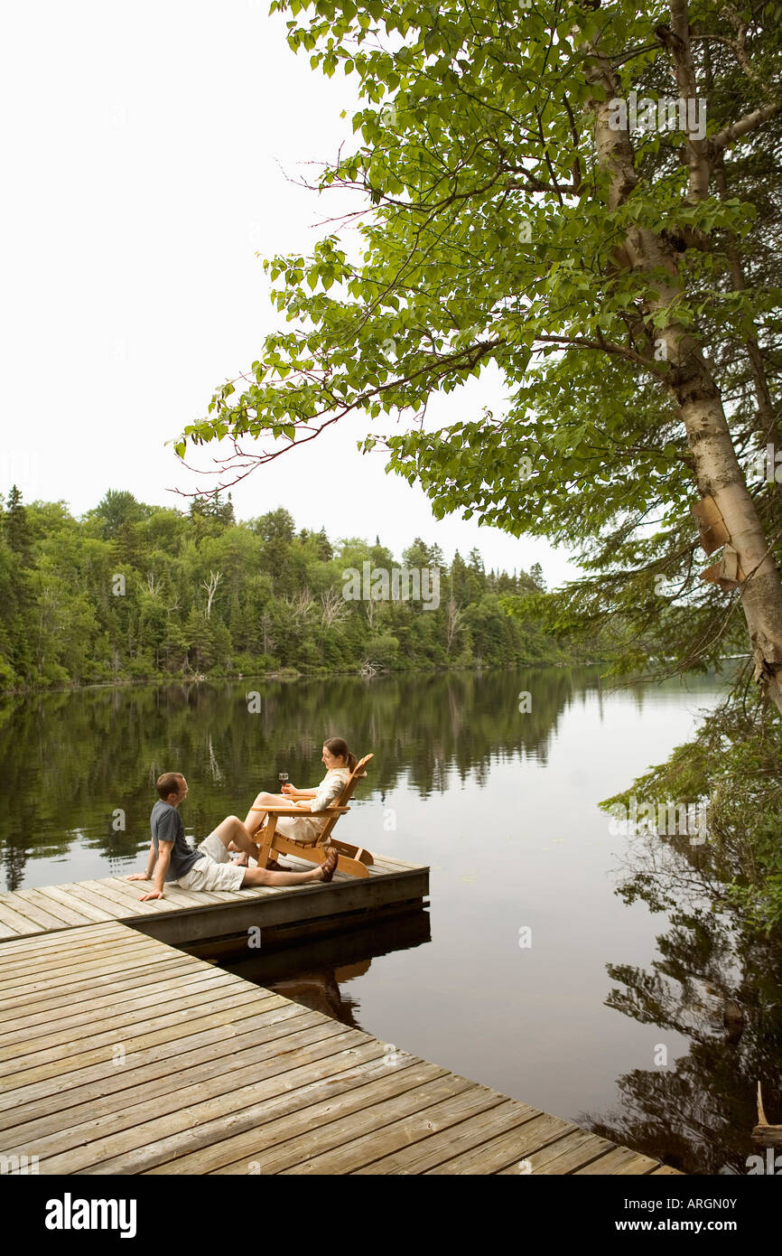 Couple on Dock by Lake Stock Photo