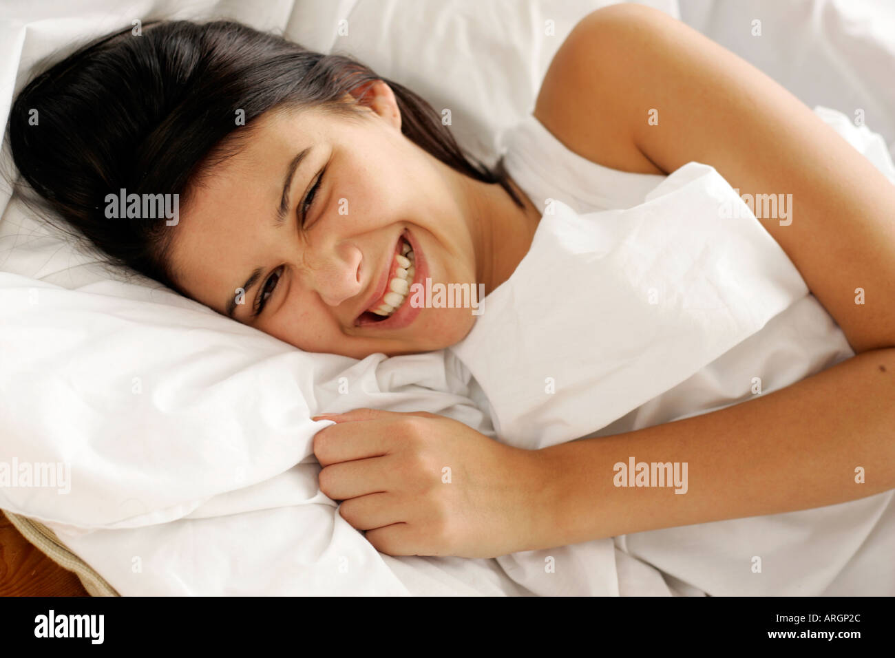 Brunette girl in bed Stock Photo