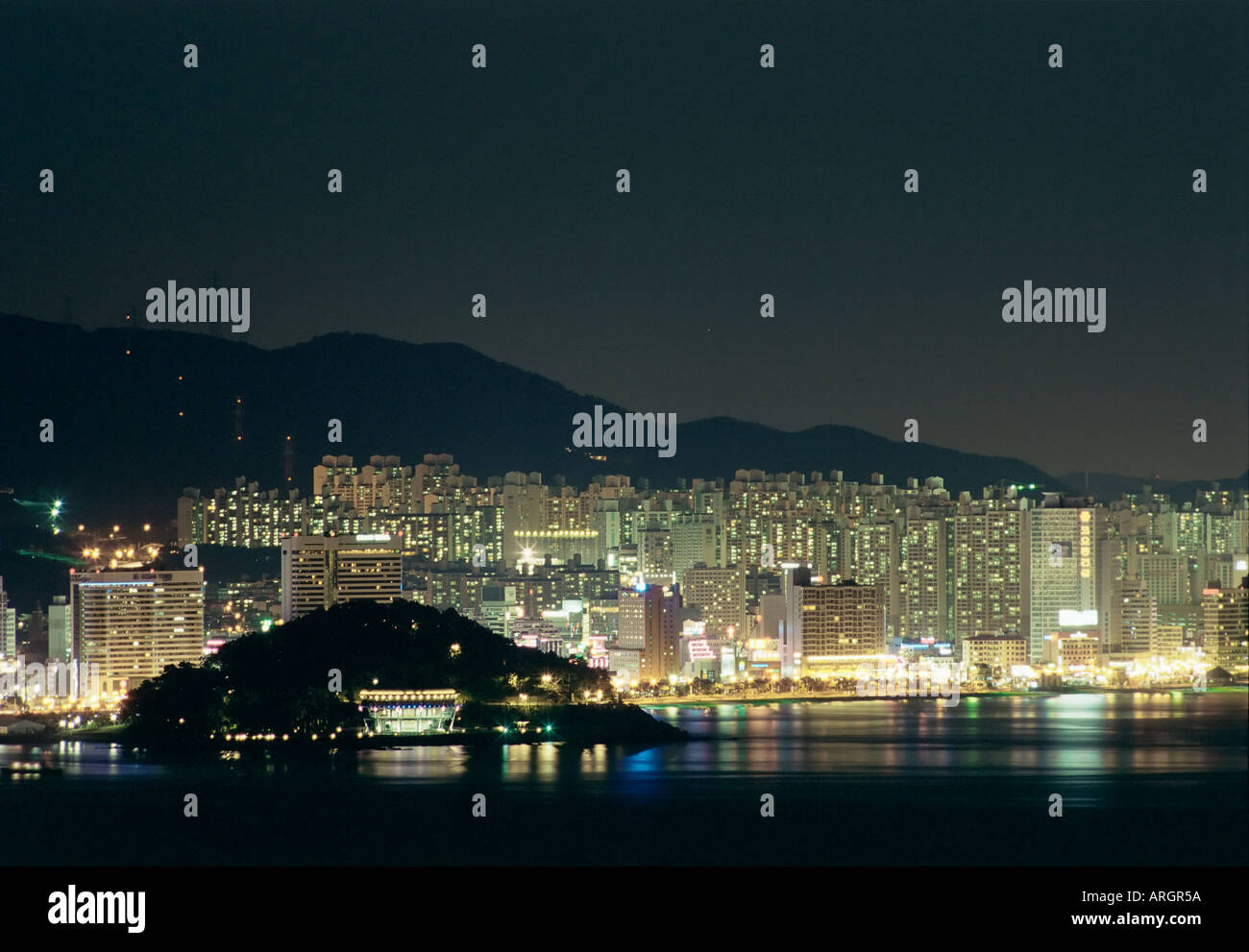 Nightly view of Nurimaru APEC venue with Haeundae Beach in the background; Busan, South Korea Stock Photo