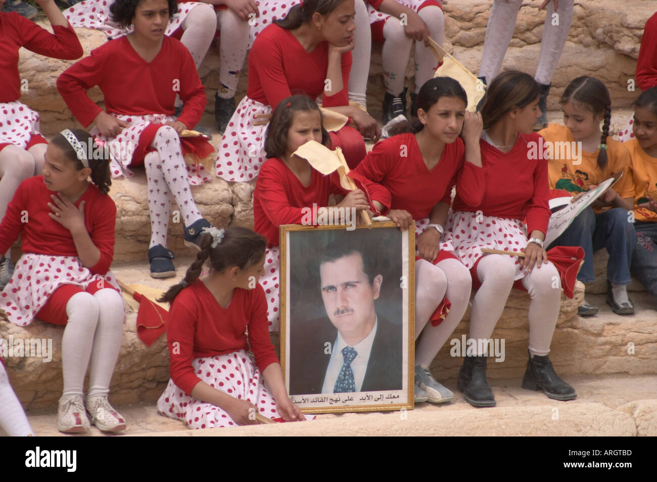 Palmyra Syria Concert for president Assad and Bassar al Assad Children dancind holding portrait of their president Stock Photo