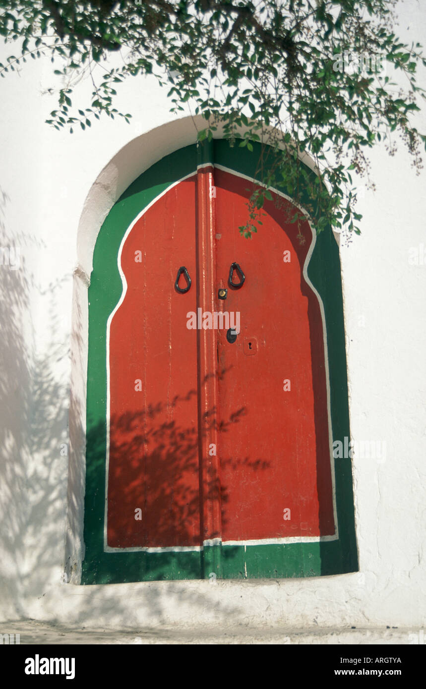 Brightly painted in red and outlined in deep green a Hammam bathhouse door in the village of Sidi Bou Said Stock Photo