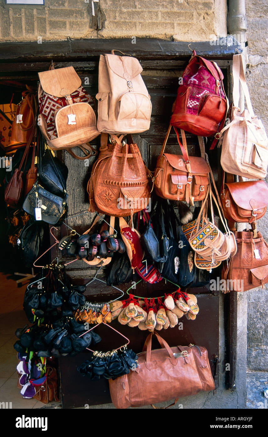 A collection of bags and purses hang outside a shop door in Toledo Stock Photo