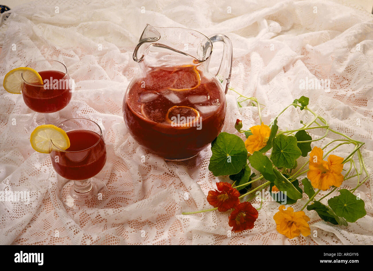 A bunch of nasturtiums beside a jug filled with Sangria a mixture of