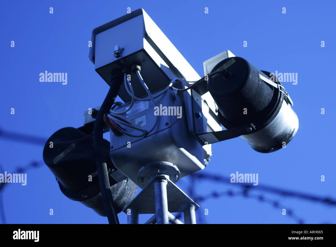 Security fence wire razor wire surveillance Stock Photo - Alamy