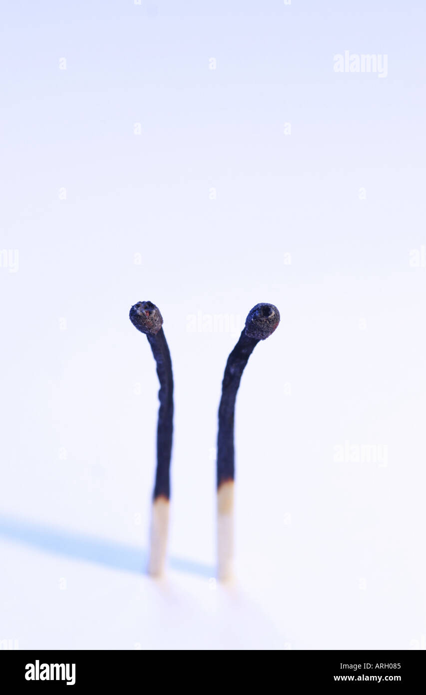 Two burn matches Stock Photo
