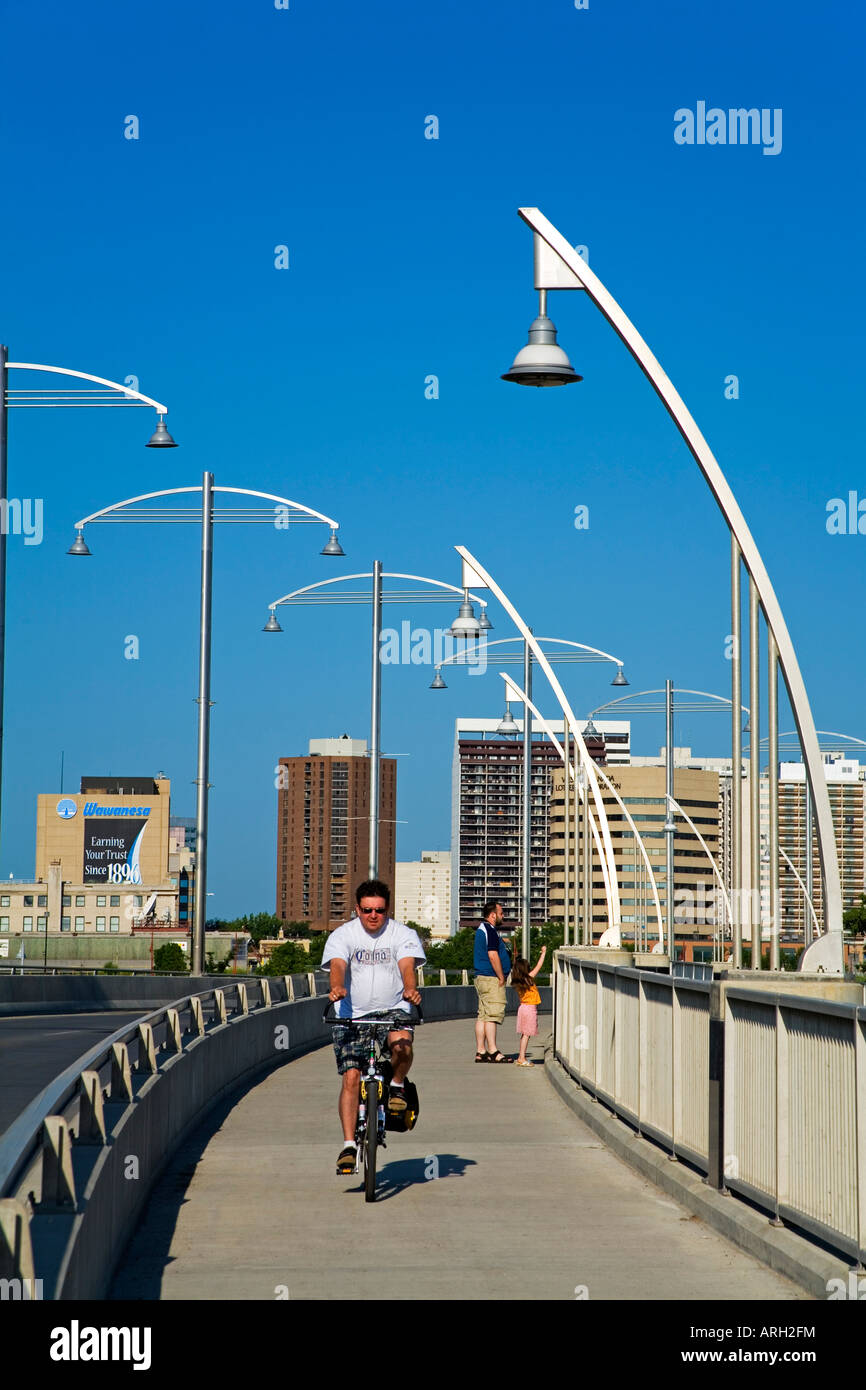 Man riding a bicycle on the bridge, Provencher Bridge, Winnipeg, Manitoba, Canada Stock Photo