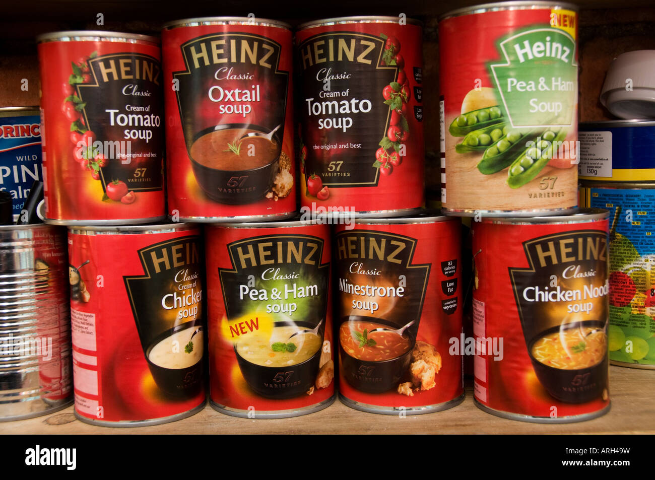 various assorted varieties tin cans of Heinz soups on a kitchen Stock