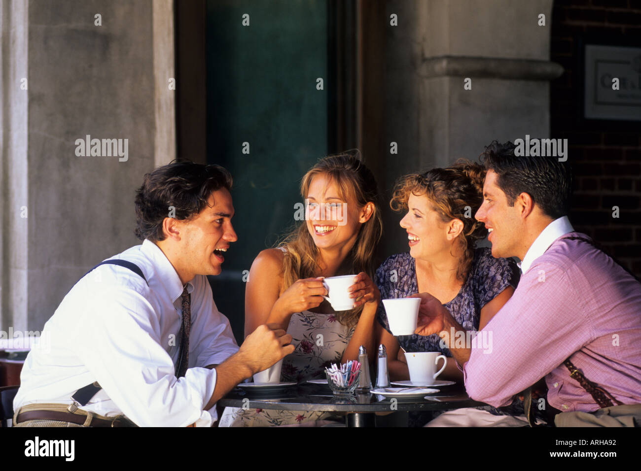 Two young couples age 20s having coffee in cafe Stock Photo