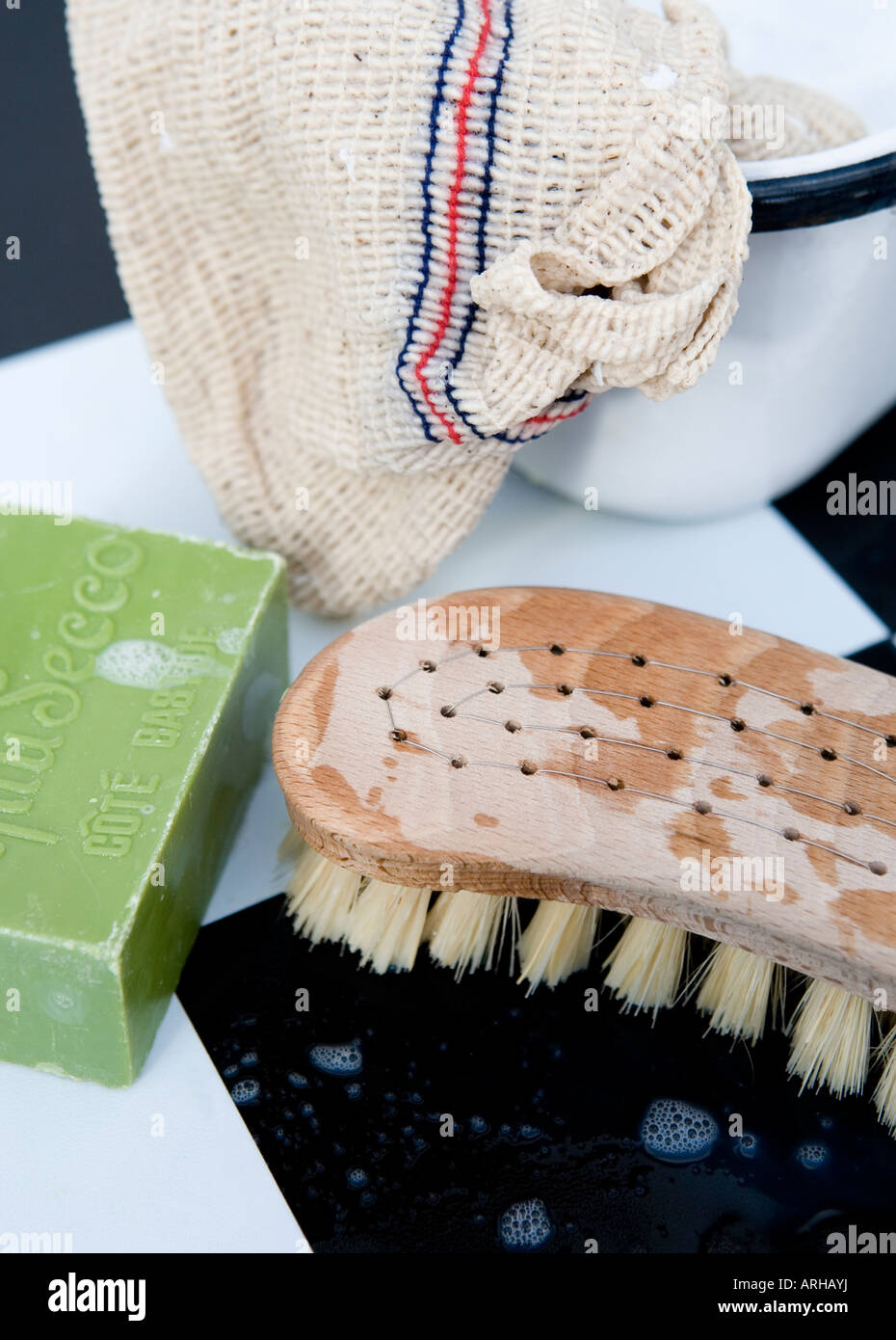 Cleaning with a traditional wooden scrubbing brush, household soap, traditional cloth with a vintage enamel bowl Stock Photo
