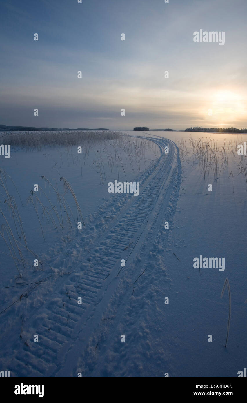 Snowmobile tracks on lake ice, Finland Stock Photo