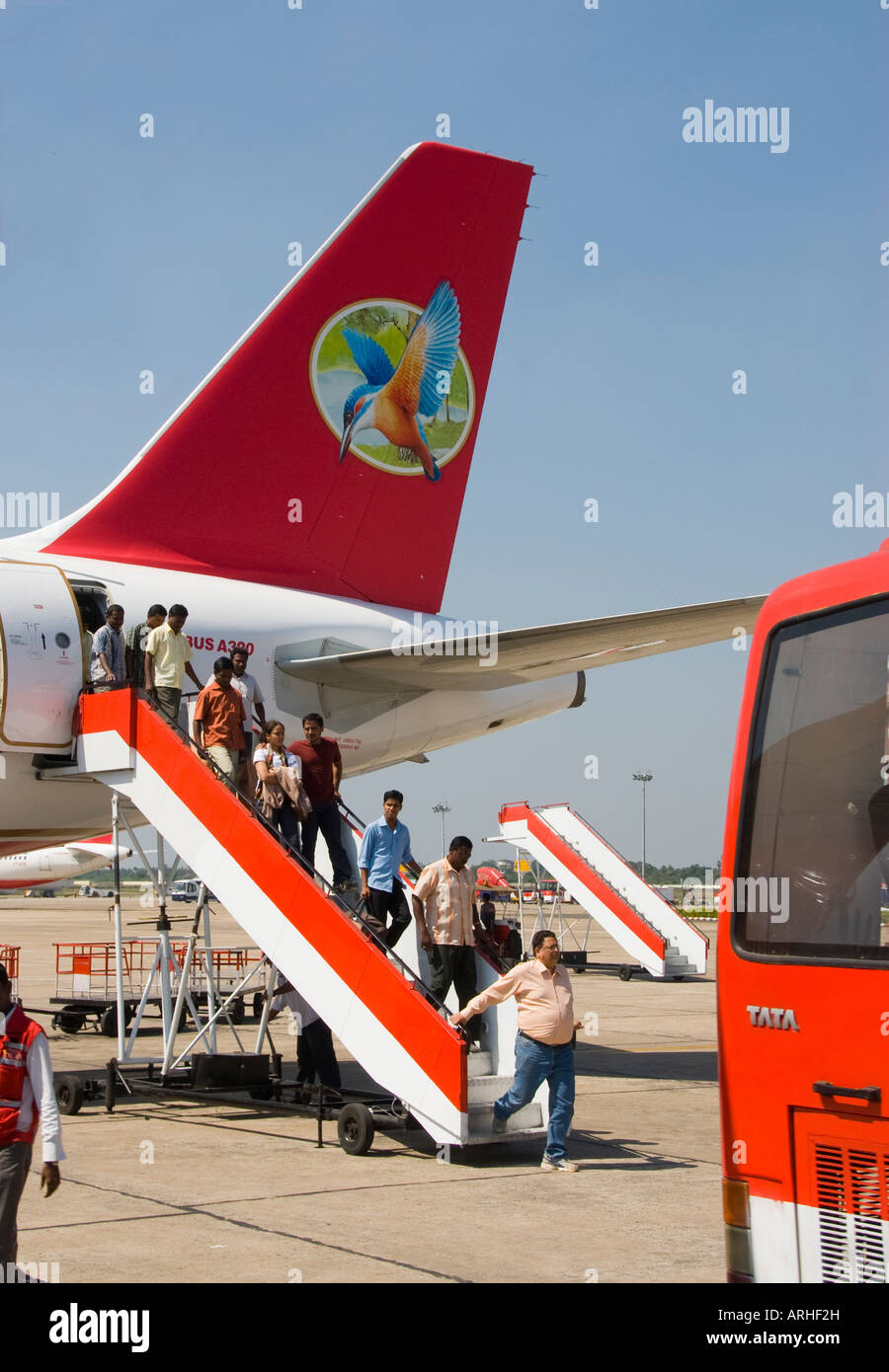 Indian passengers leaving a jet at an airport in India Stock Photo