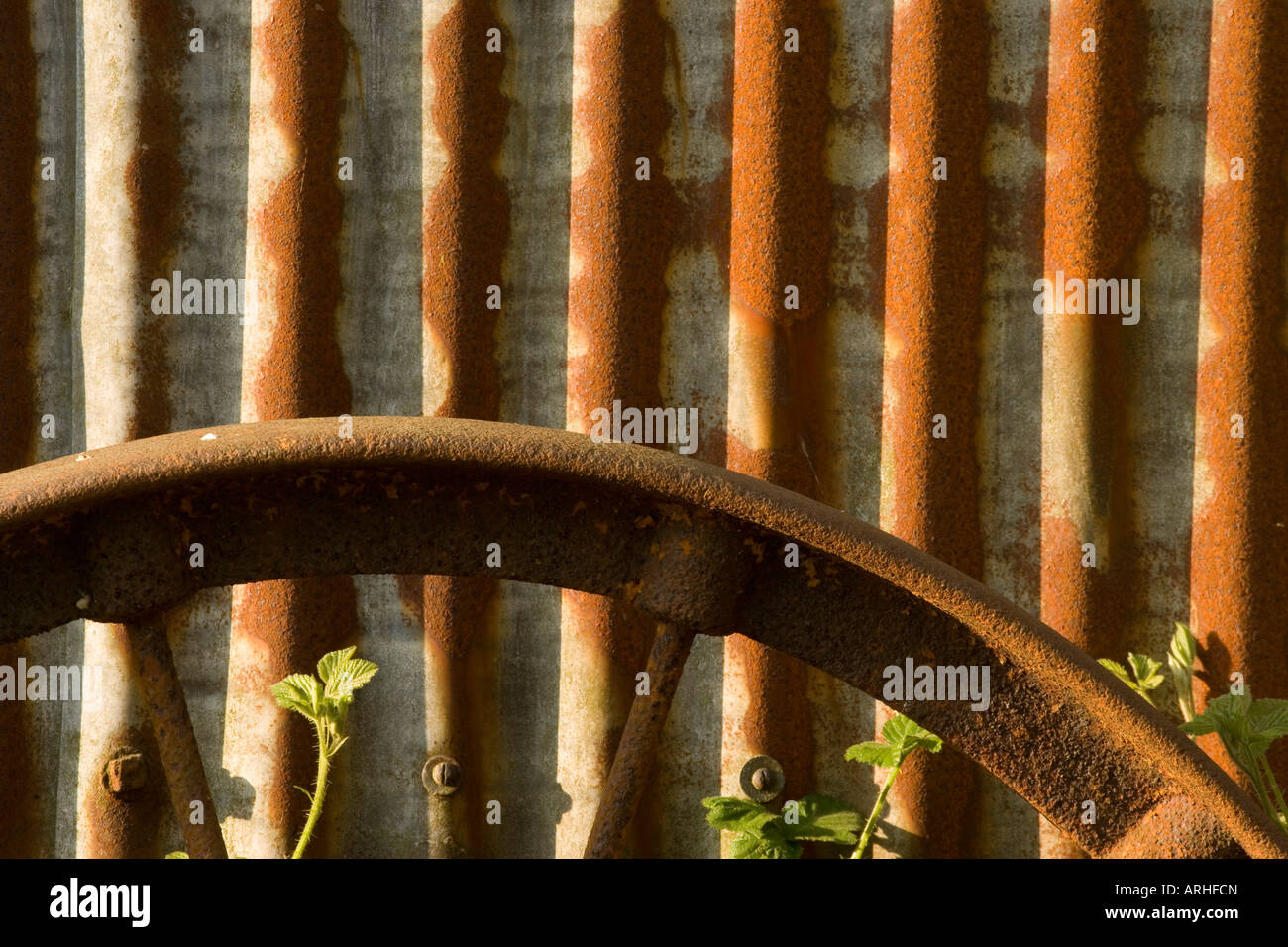 Wheel rim and corrugated iron Stock Photo