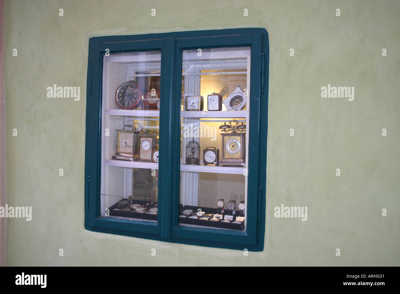 double fronted blue framed window display of clocks in Prague Stock ...