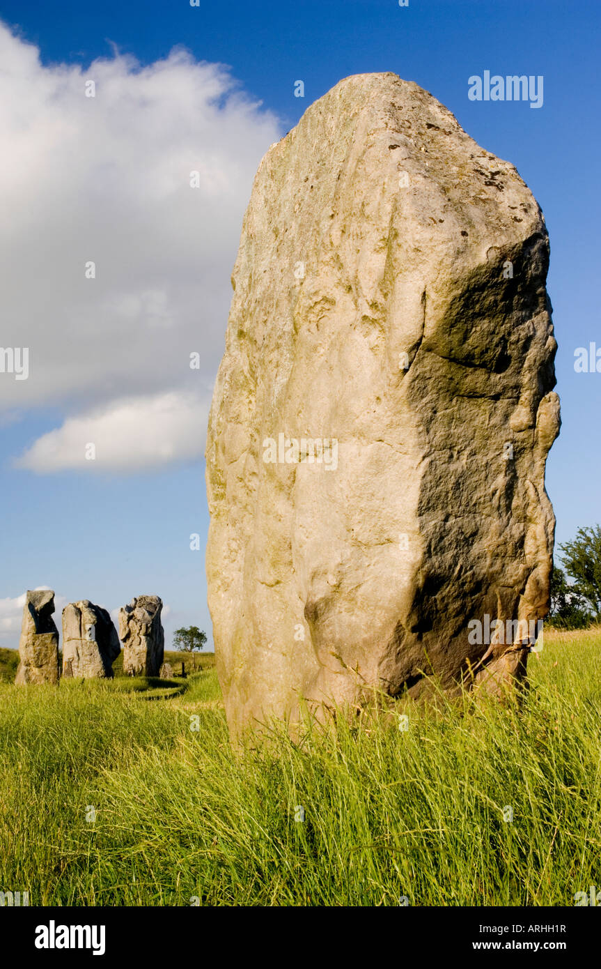 One of the neolithic Standing stones with others in the distance at Avebury Wiltshire UK Stock Photo