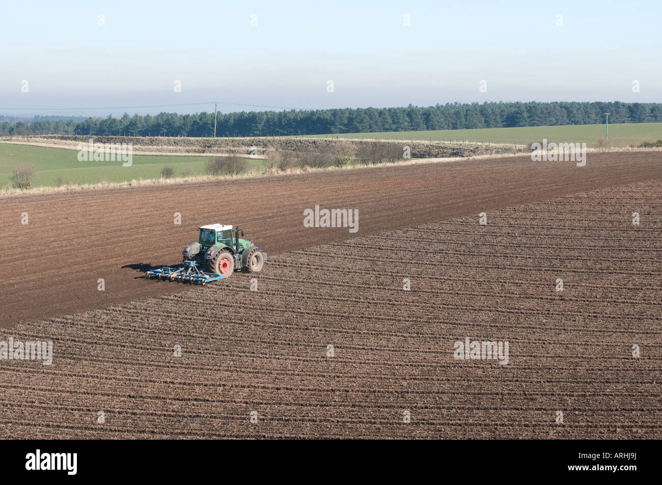 tractor in field ploughing soil Stock Photo Alamy