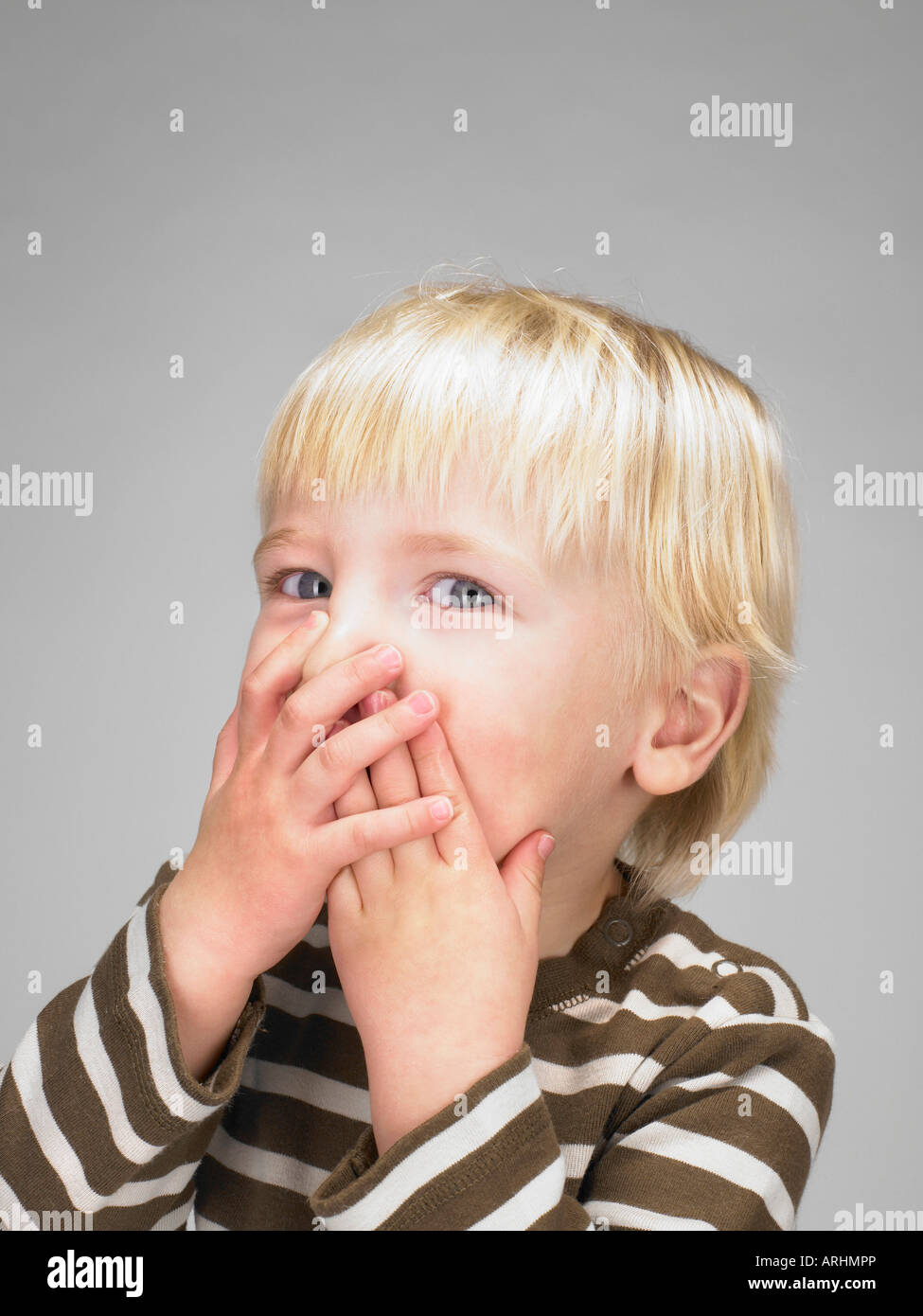 little-boy-covering-his-mouth-stock-photo-alamy