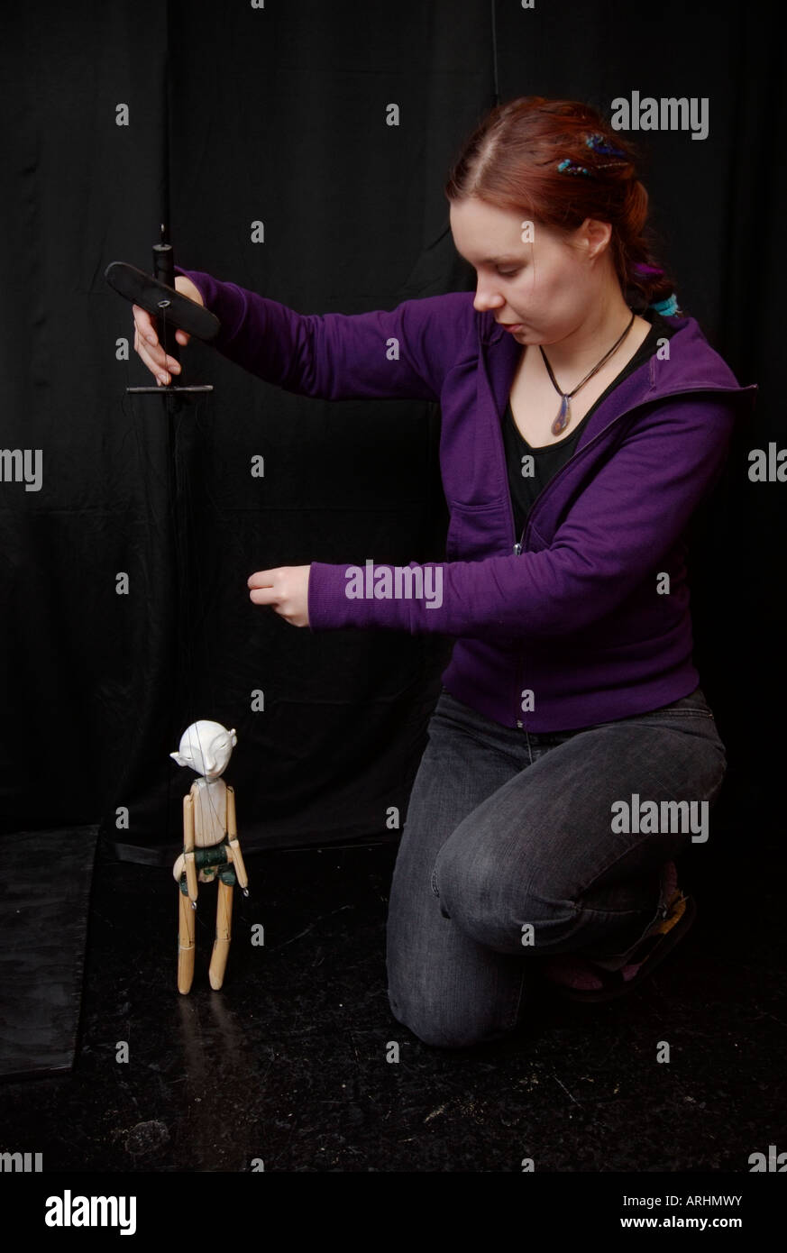 A professional puppeteer in her workshop with a marionette Stock Photo