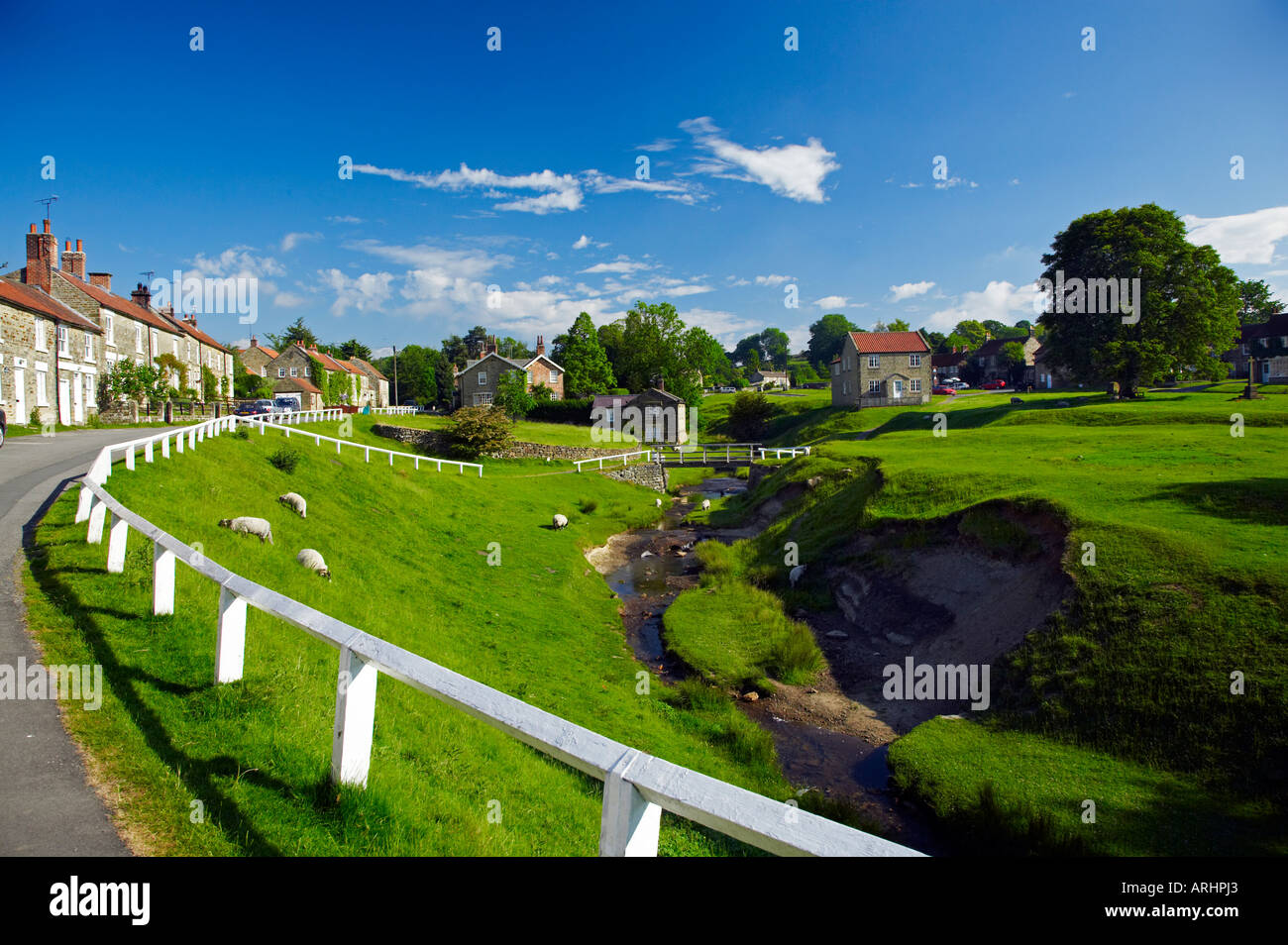 The village green west side and Hutton Beck Stock Photo