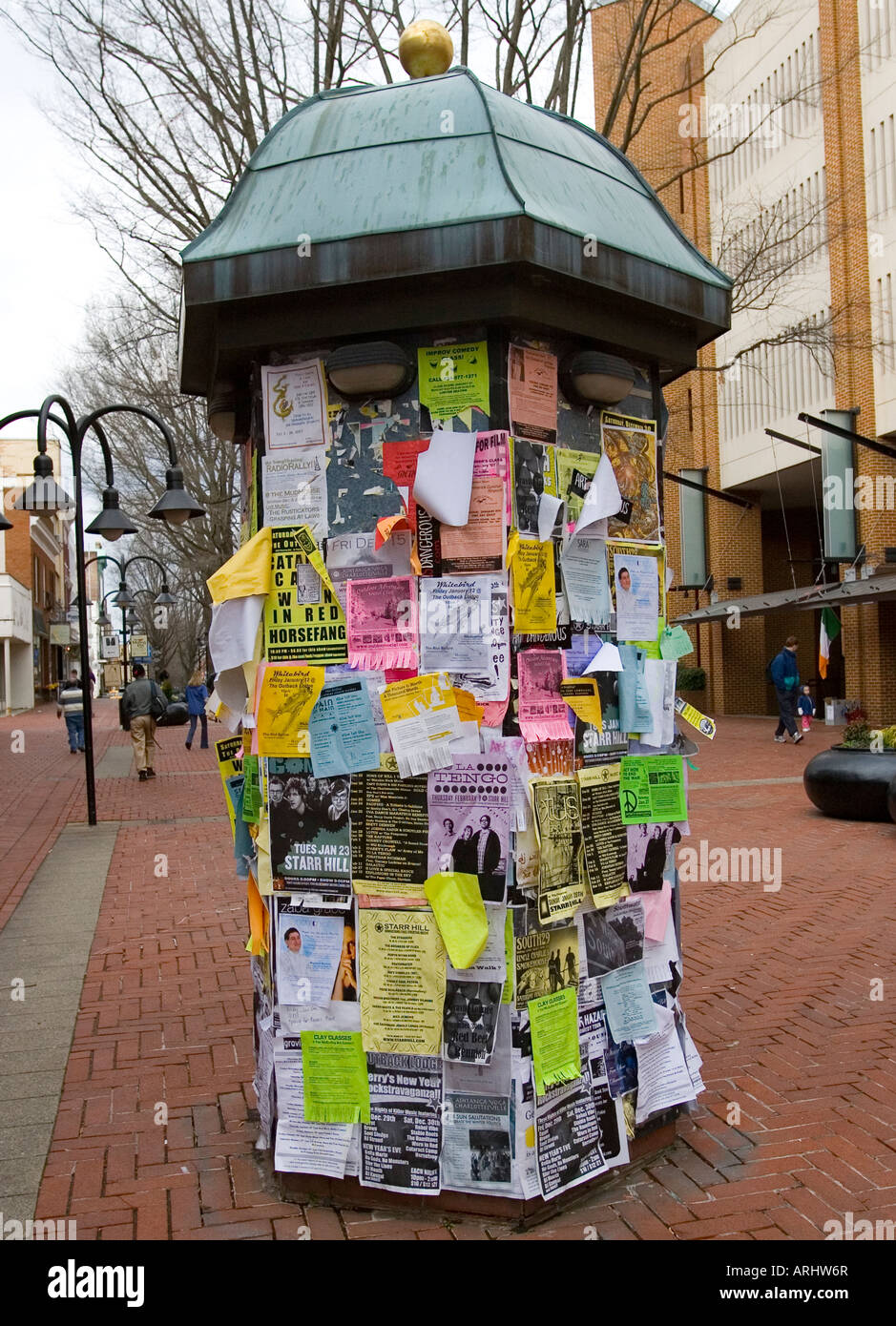 Public bulletin board with advertisements and colorful paper fliers on