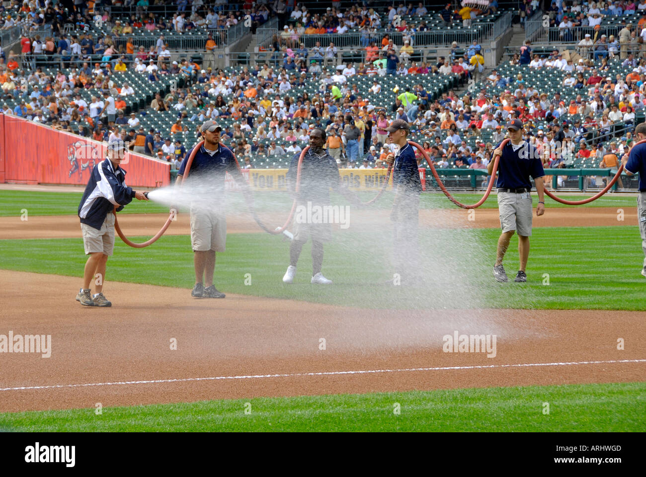 Watering or hosing down the dust on the field prior to the Detroit Tiger Professional Baseball game Stock Photo