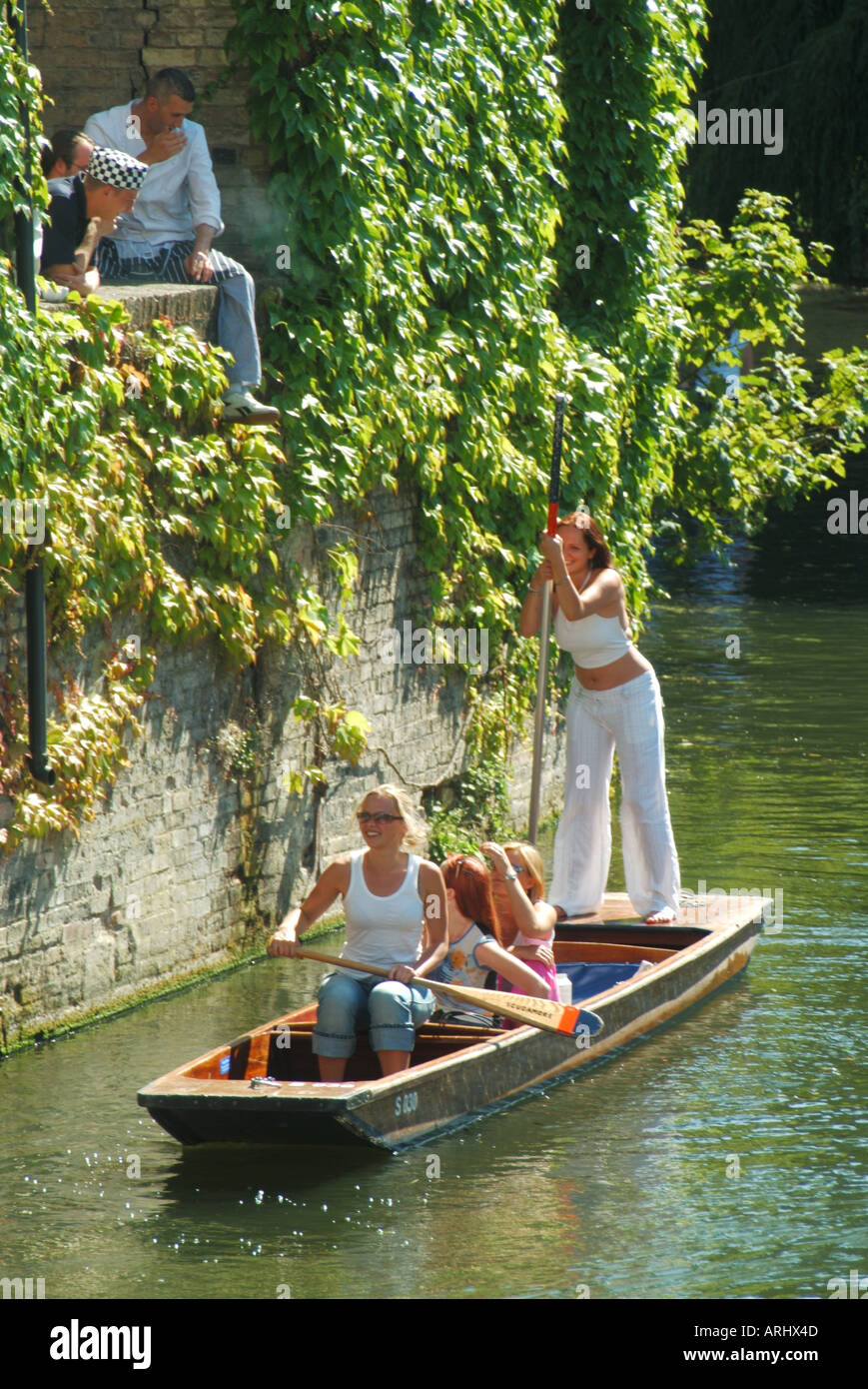 Cambridge university town punt on the River Cam near Bridge Street watched by kitchen staff Stock Photo