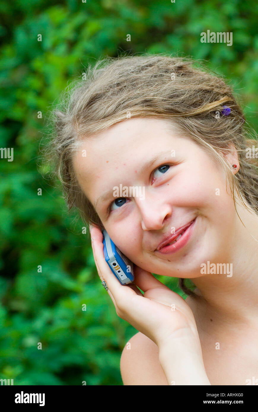 young woman girl making a phone call calling with a mobile phone smiling Stock Photo