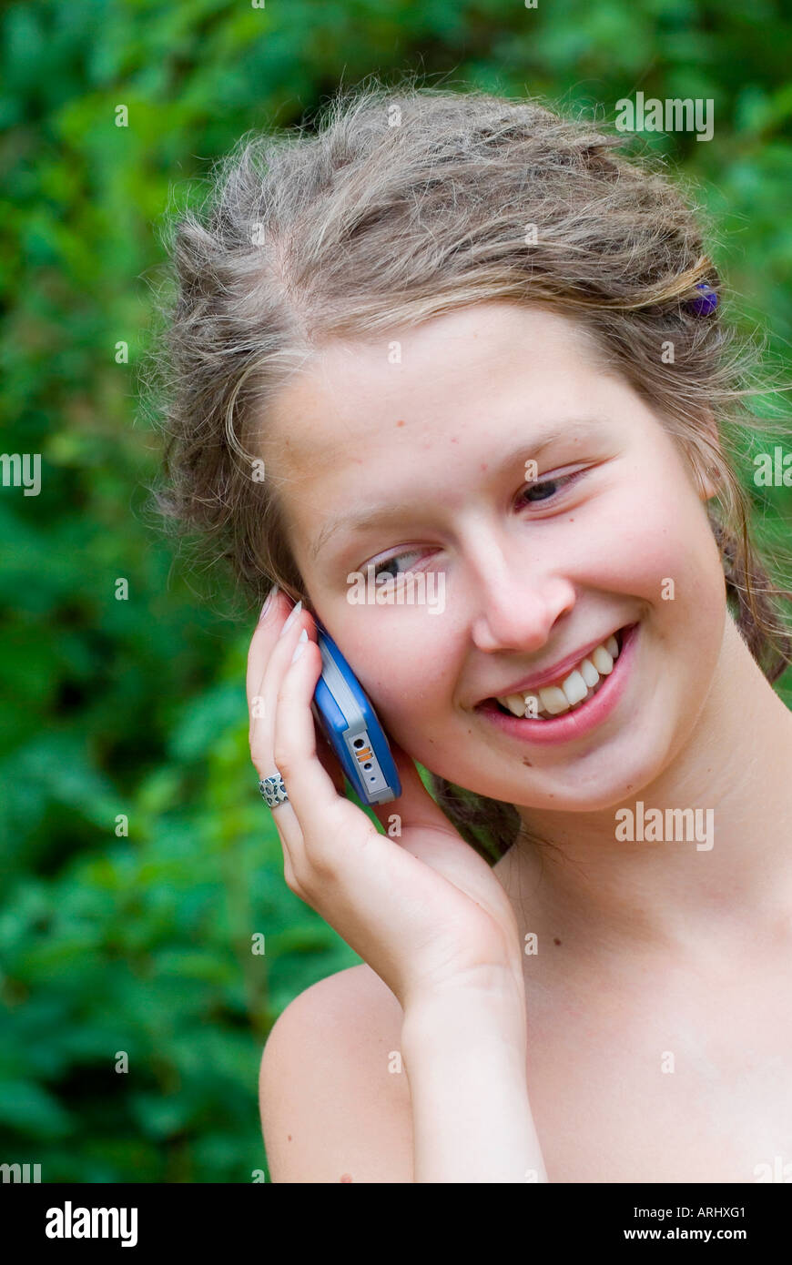 young woman girl making a phone call calling with a mobile phone smiling Stock Photo