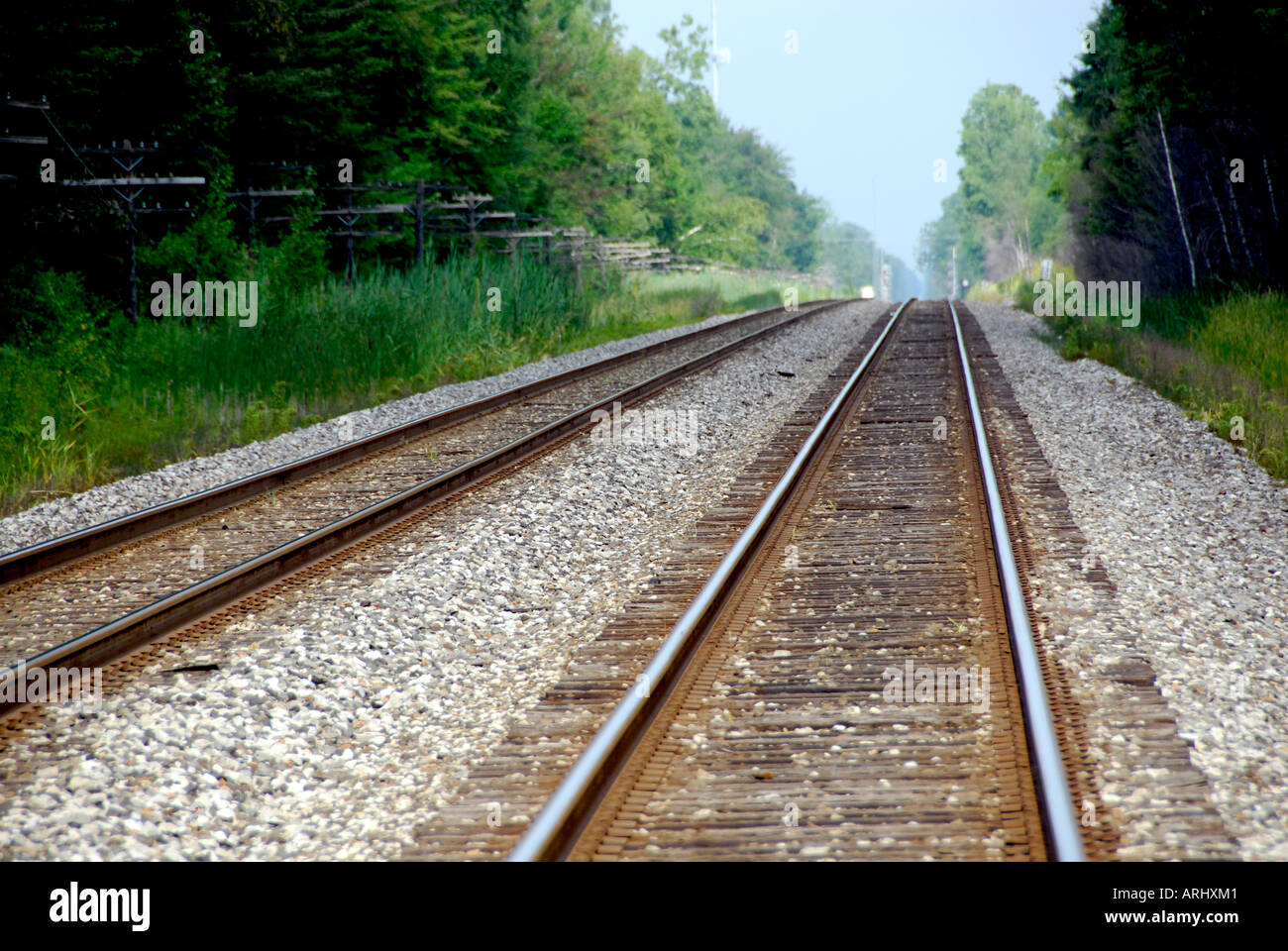 Two sets of railroad tracks lead to infinity Stock Photo