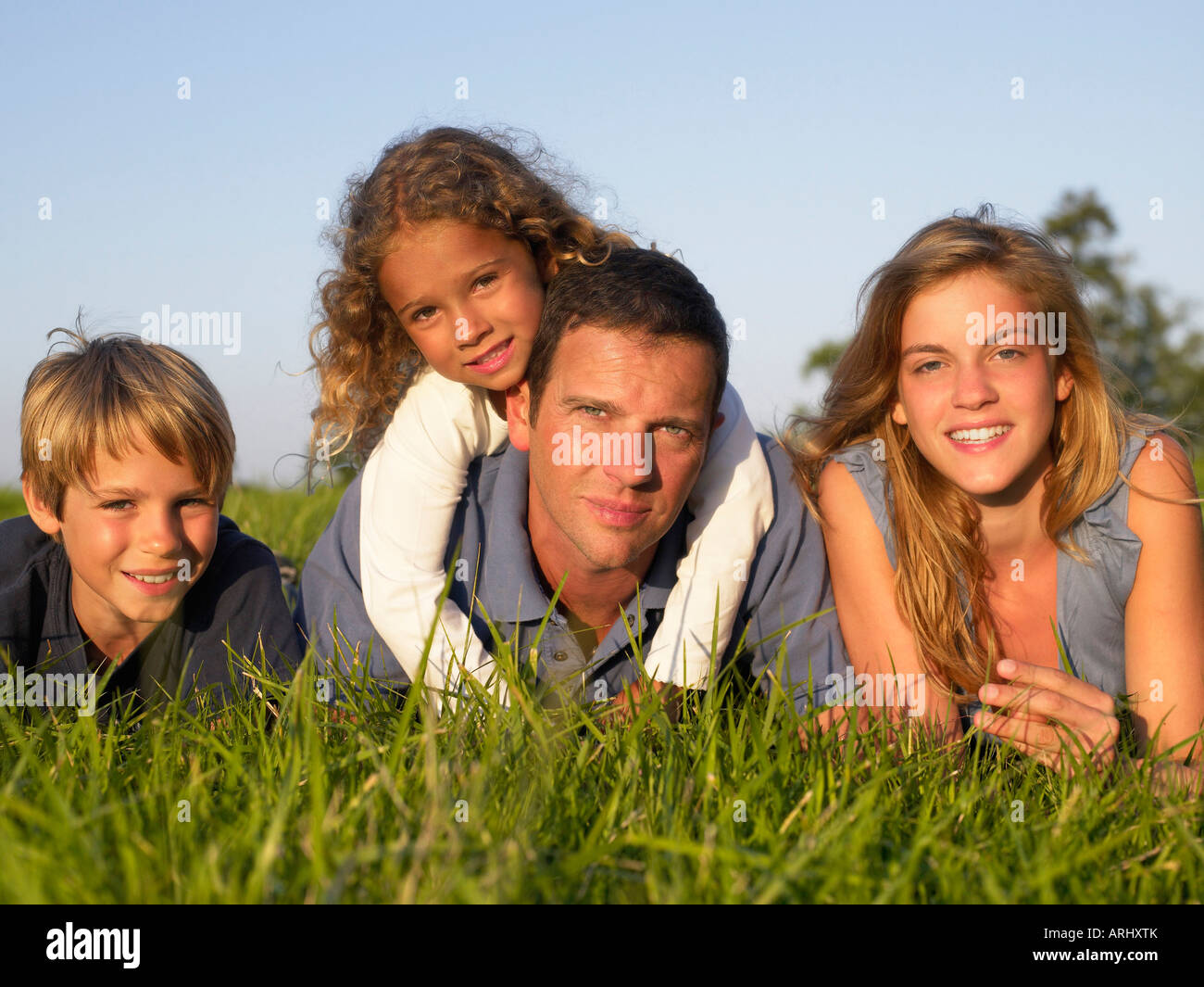 Family lying in a field Stock Photo