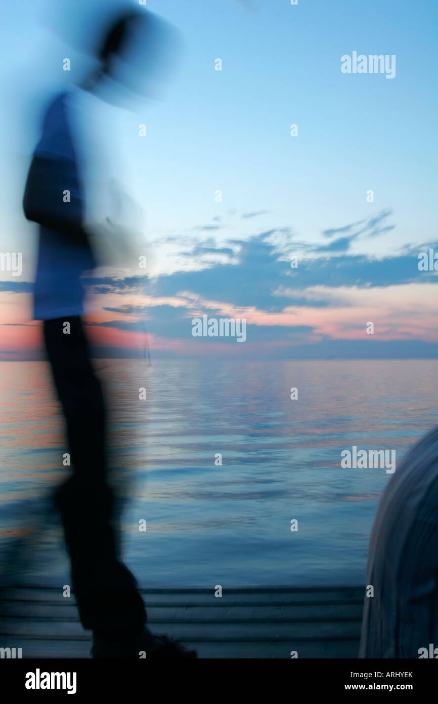 Swedish blurred action on a pier at the beachfront one summer evening in Malmo. Creative blur. Stock Photo