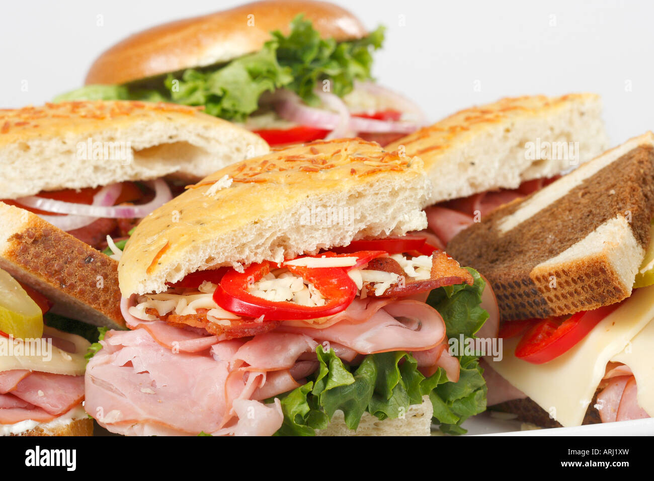 Platter of sandwiches Focaccia bread halved with Bagel on a dinning table overhead from above close up in USA US nobody horizontal hi-res Stock Photo