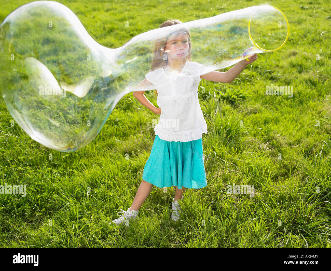 Little girl making soap bubbles Stock Photo - Alamy