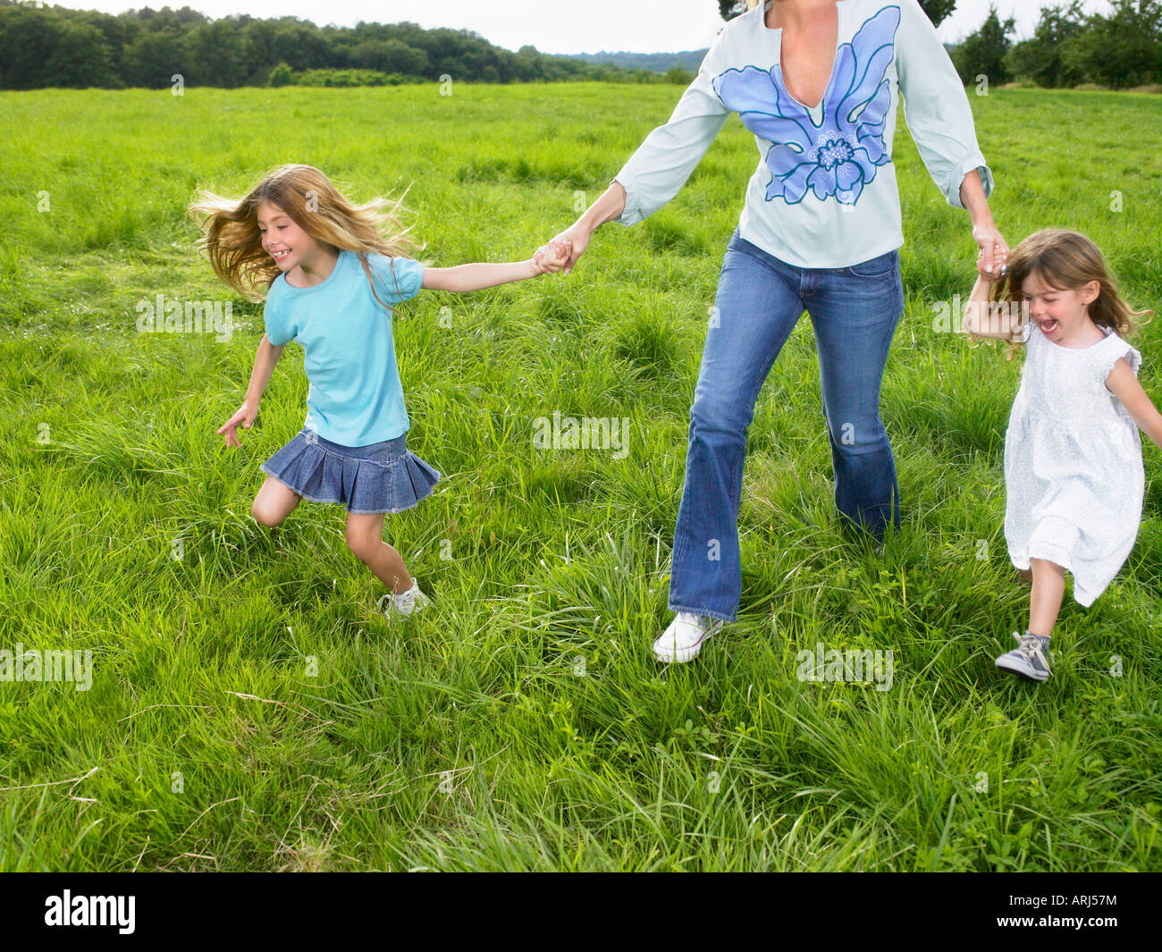 Mother and daughters in a field Stock Photo