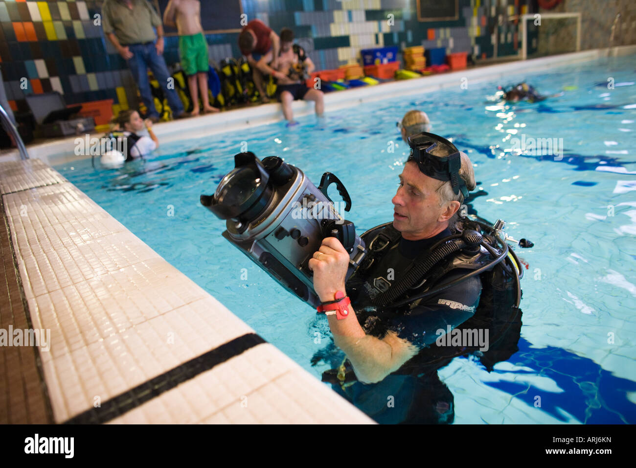 A wildlife cameraman teaches underwater filming techniques at a seminar
