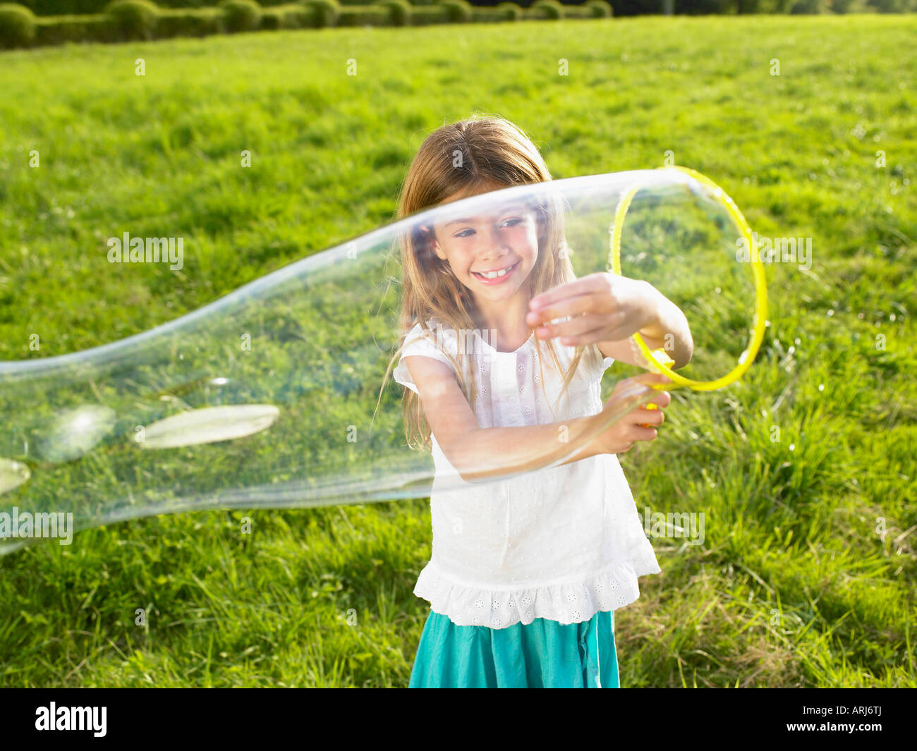 Little girl making soap bubbles Stock Photo Alamy
