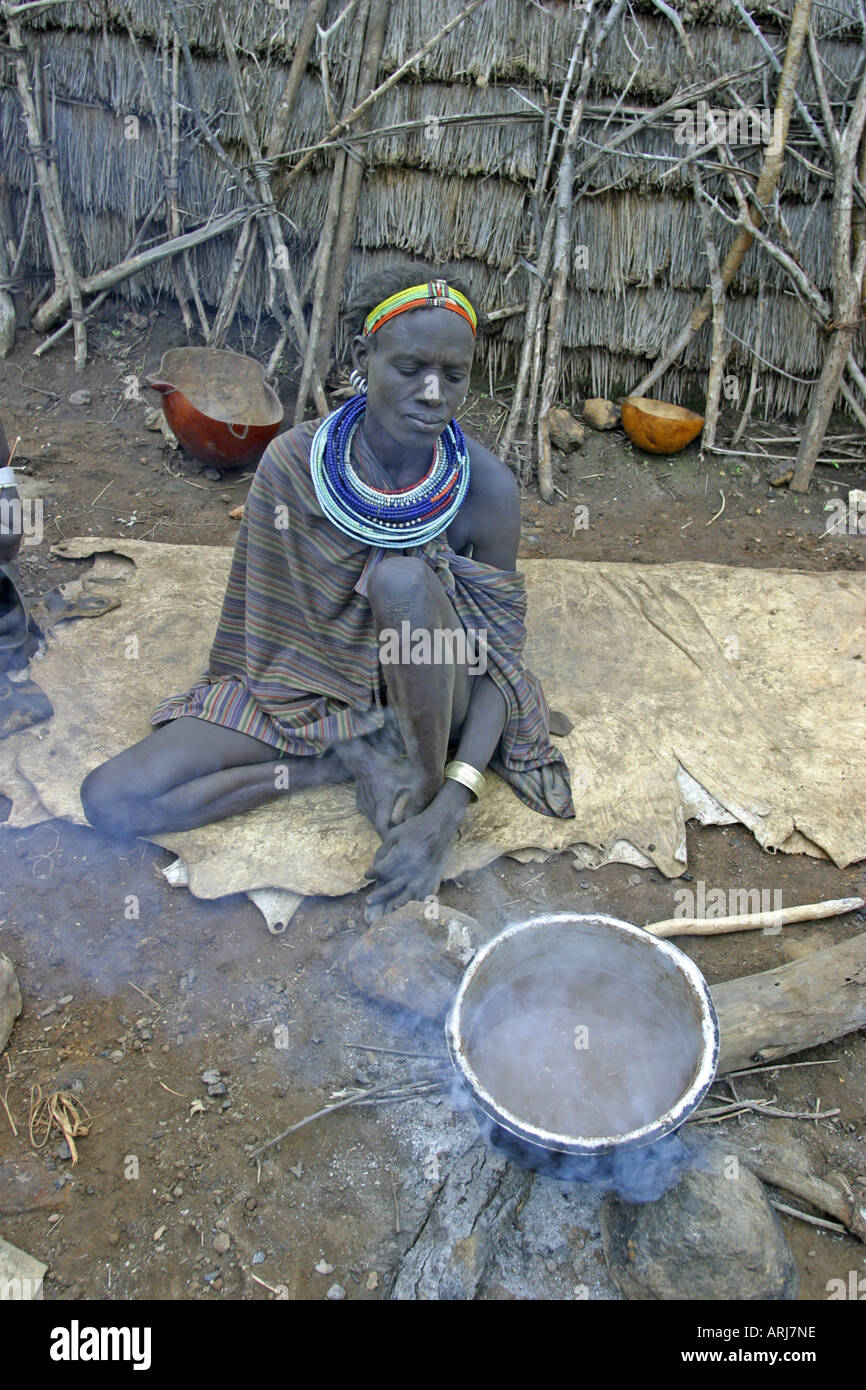 Toposa woman cooking millet gruel hires stock photography and images