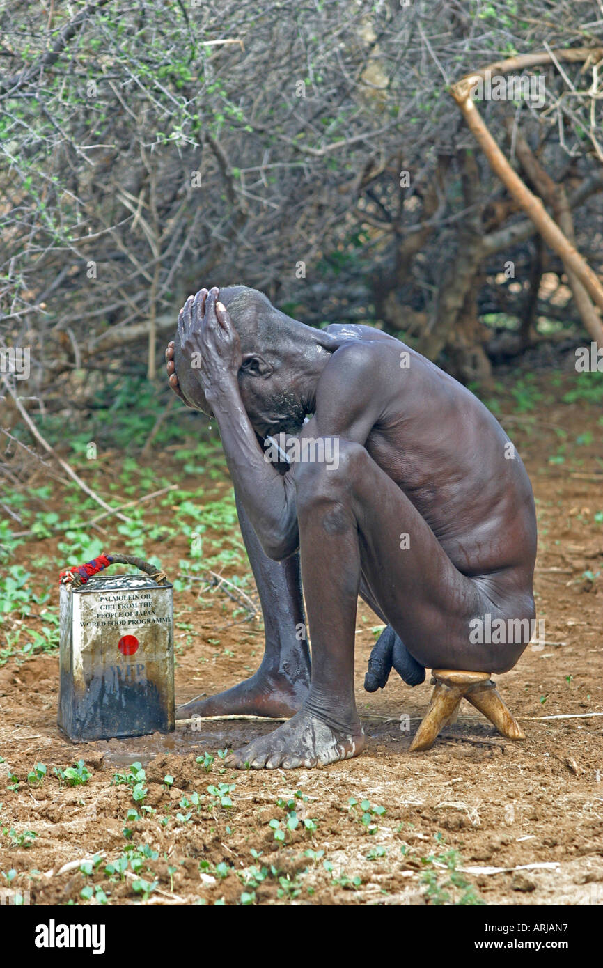 Toposa Fish Toposa-man sitting on and washing oneself, Sudan Stock Photo - Alamy
