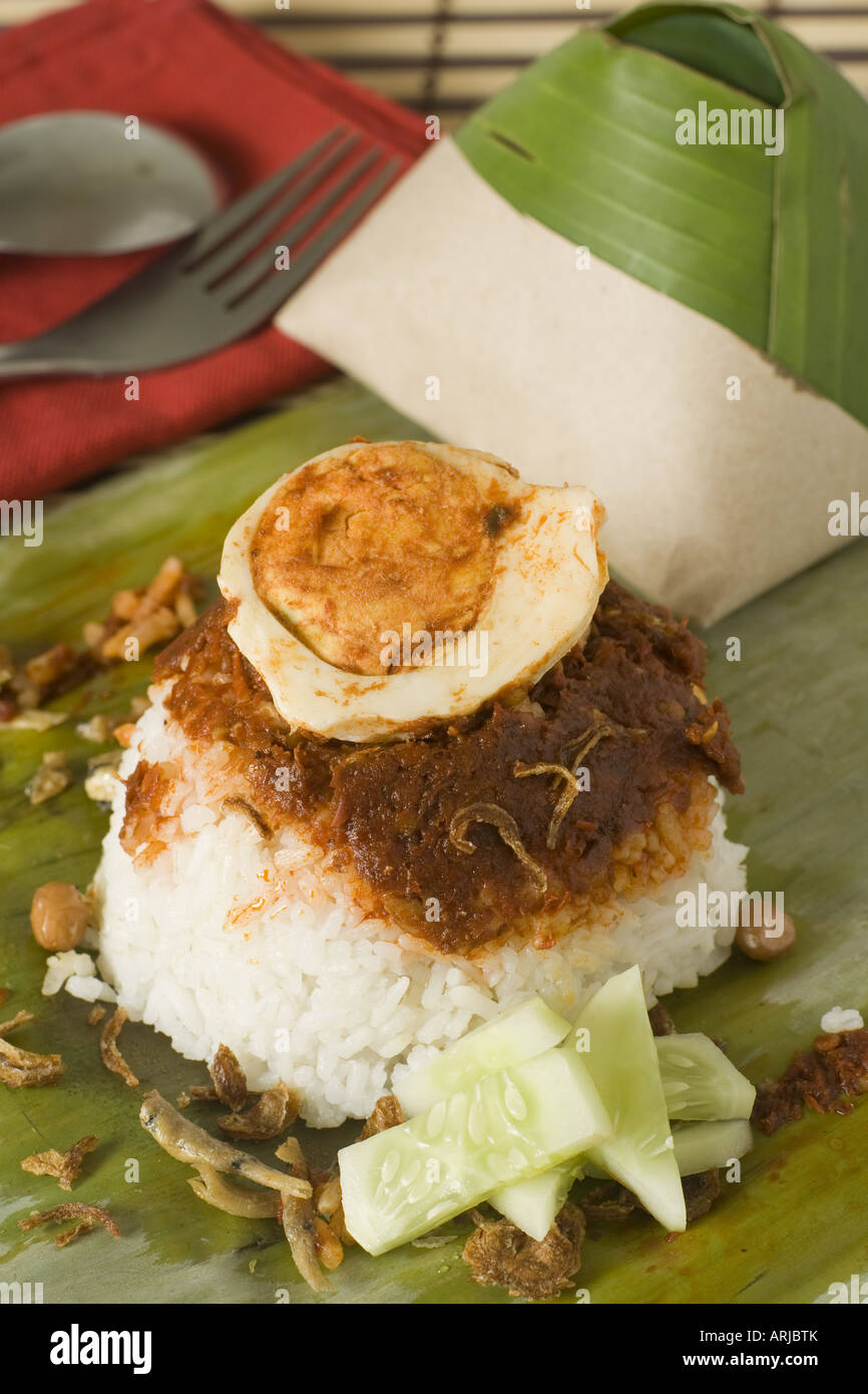 The popular Malaysian breakfast snack nasi lemak, rice cooked in coconut milk served with hot sauce Stock Photo