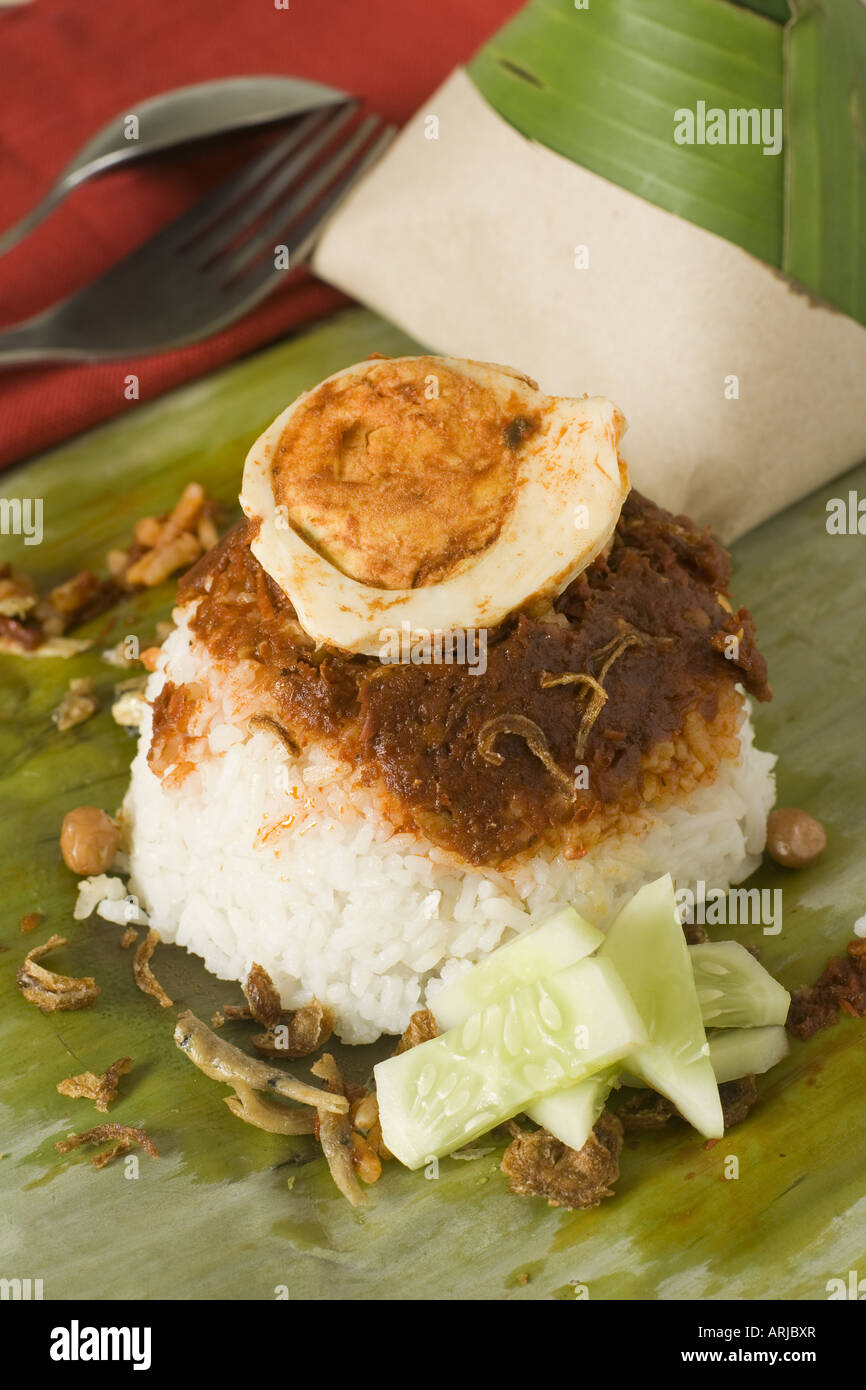 The popular Malaysian breakfast snack nasi lemak, rice cooked in coconut milk served with hot sauce Stock Photo