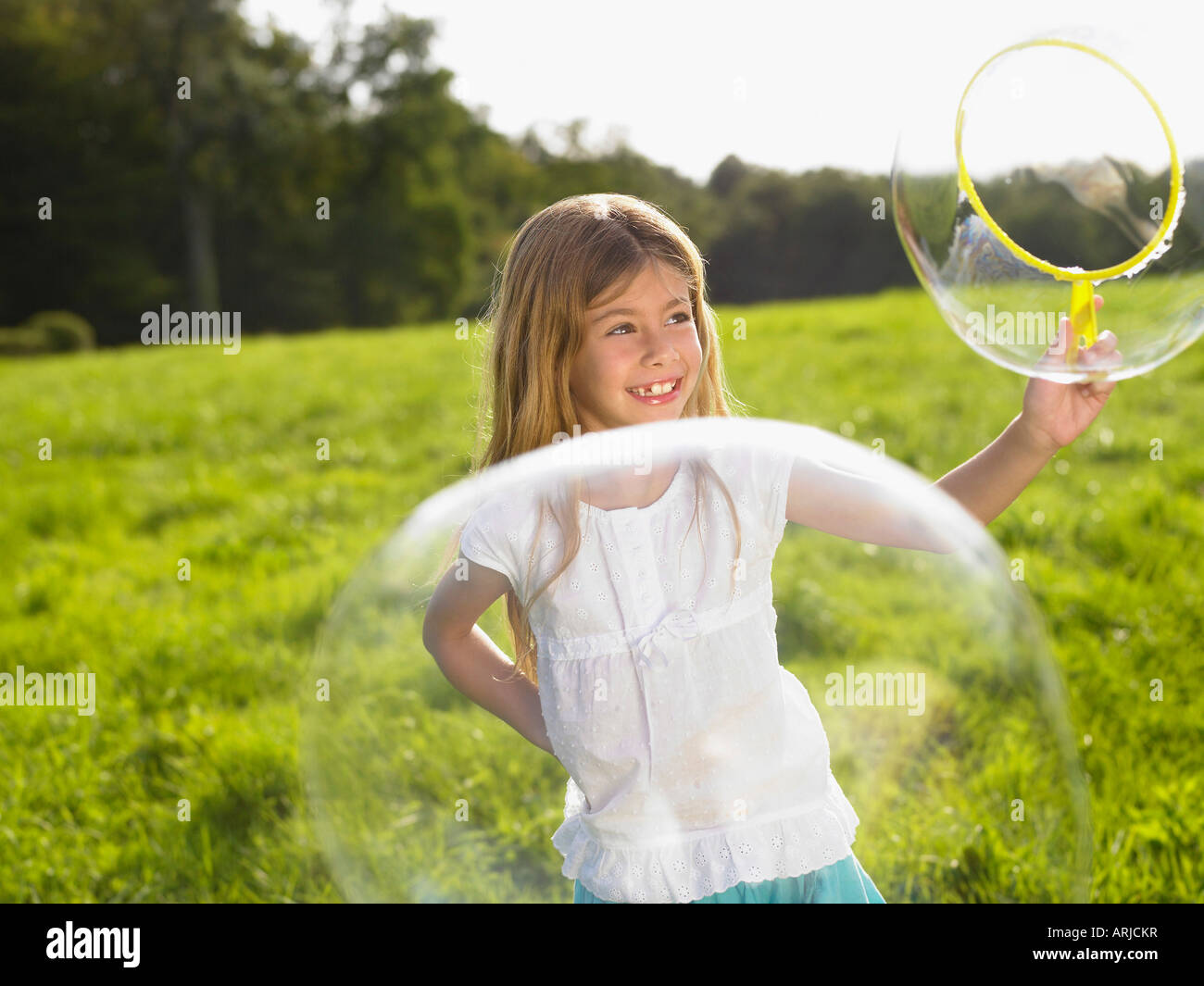 Little girl making soap bubbles Stock Photo - Alamy