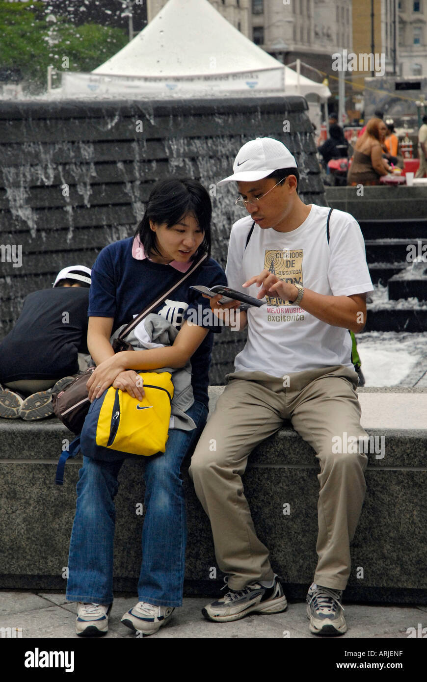 Husband and wife look over a map to determine directions in downtown