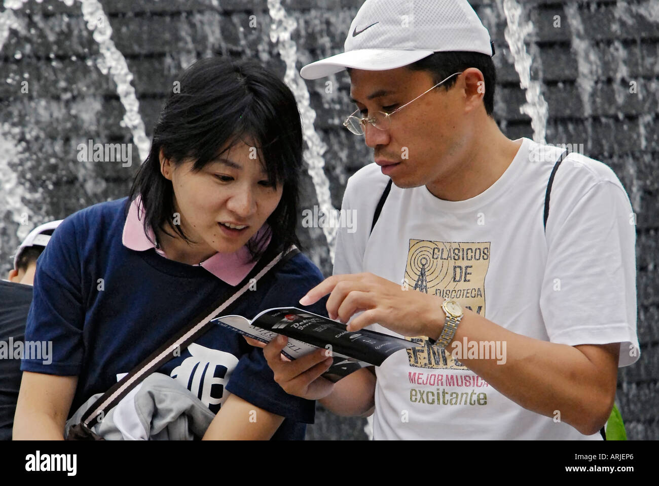 Husband and wife look over a map to determine directions in downtown