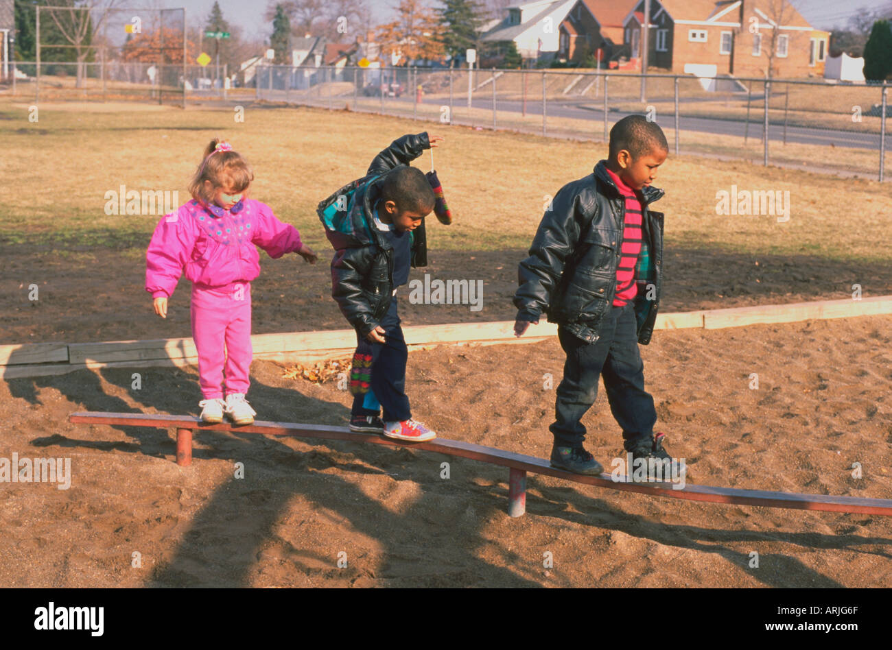 Preschoolers playing on school yard playground age 4. St Paul Minnesota