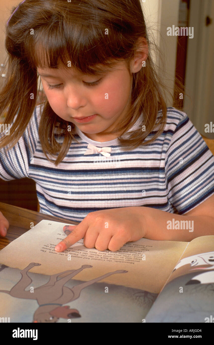 Preschooler age 5 reading picture book. Western Springs Illinois IL USA