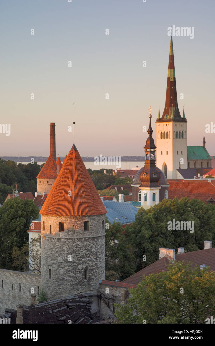 Medieval town walls and spire of St. Olav's church at dusk, Tallinn, Estonia, Baltic States, Europe Stock Photo