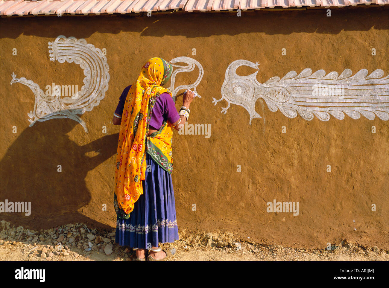 Woman decorating her house with traditional local designs, Tonk region, Rajasthan, India, Asia Stock Photo