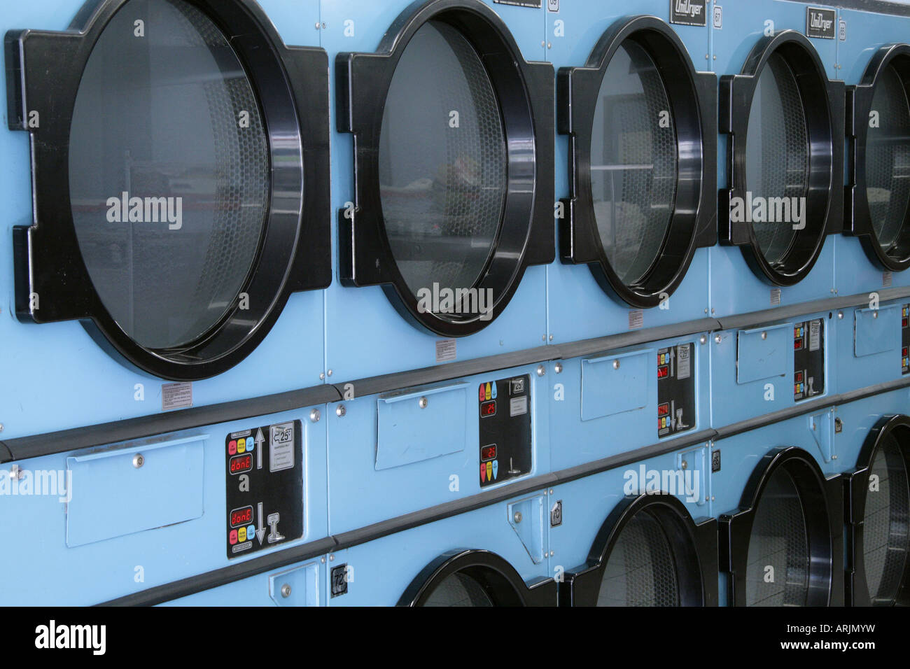 Rows of clothes dryers in laundromat Stock Photo Alamy