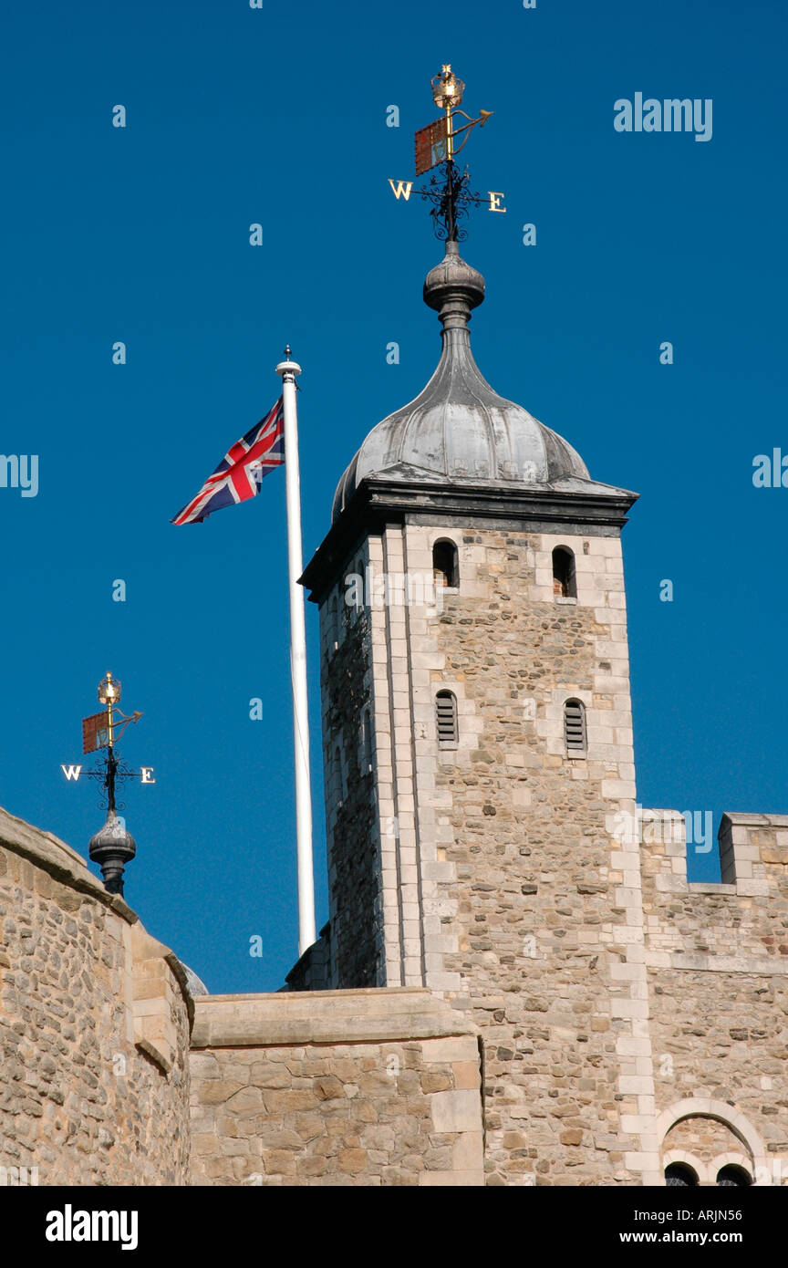 The Union Flag flies beside a tower at the Tower of London. Stock Photo
