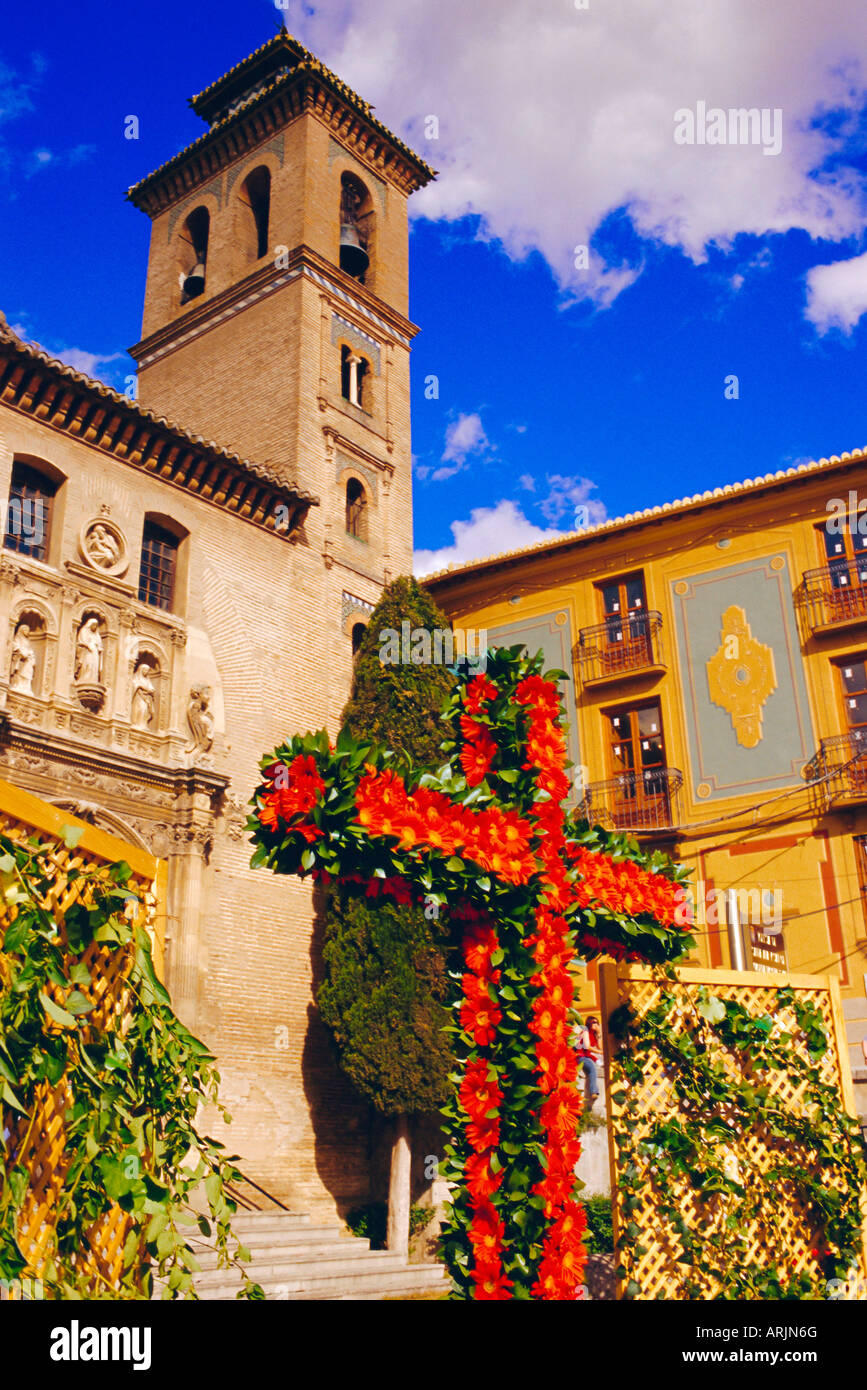 Dia de la Cruz, floral cross with Santa Ana church in the background, Plaza Nova, Granada, Andalucia, Spain Stock Photo